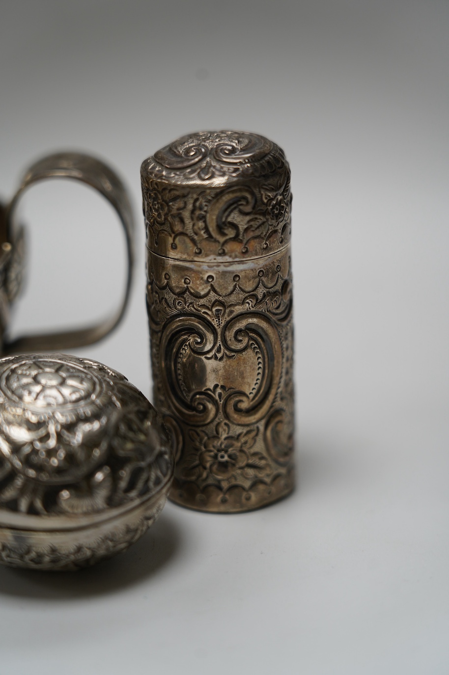 An Edwardian silver replica of a Mycenaean cup, Nathan & Hayes, Chester, 1912, height 62mm, together with a late Victorian silver mounted scent flask, two silver condiments and an Indian white metal box and cover. Condit